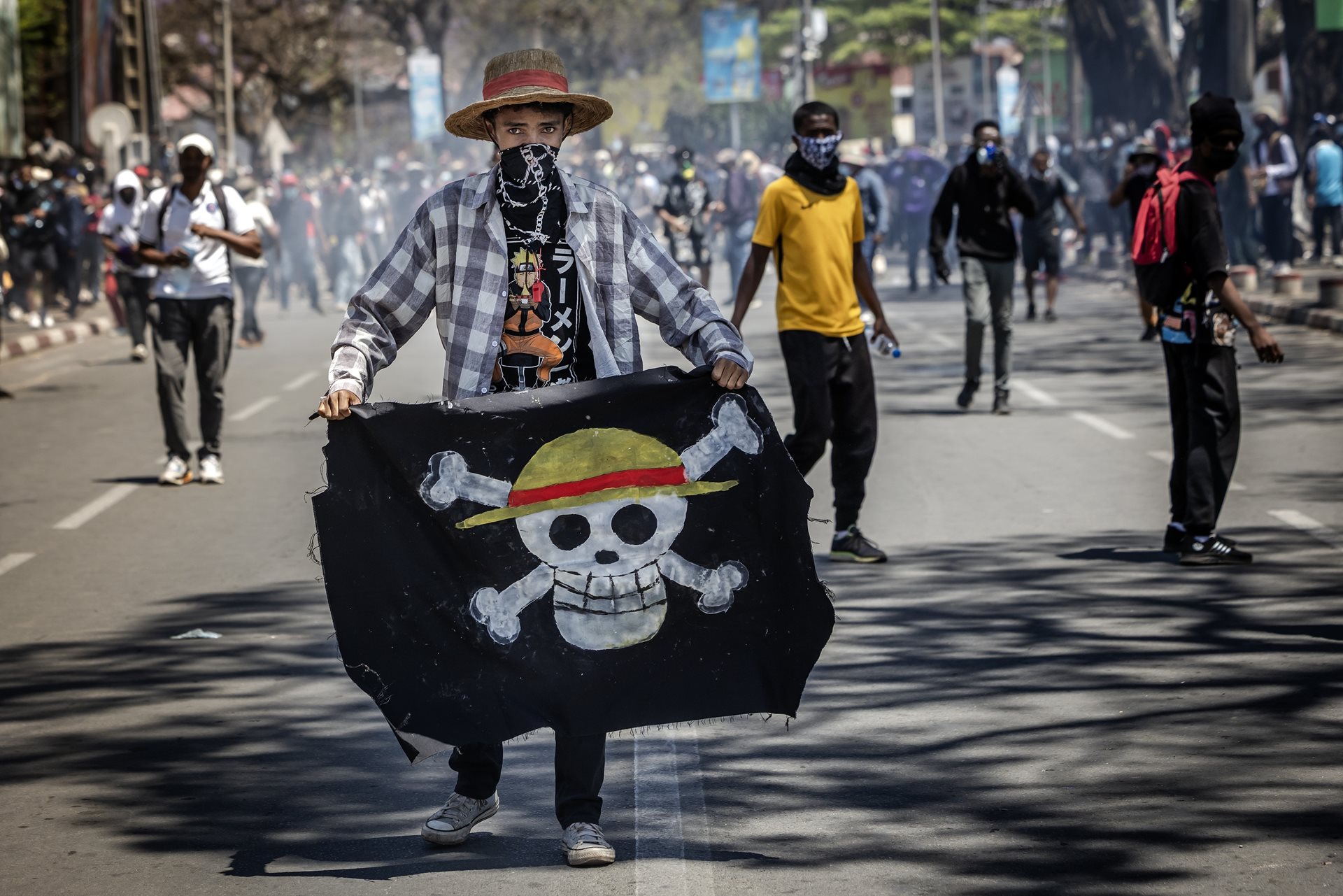A student holds the flag adopted by Gen Z protesters globally. The symbol comes from the Japanese manga One Piece, in which pirates stand up to corrupt rulers. Antananarivo, Madagascar.